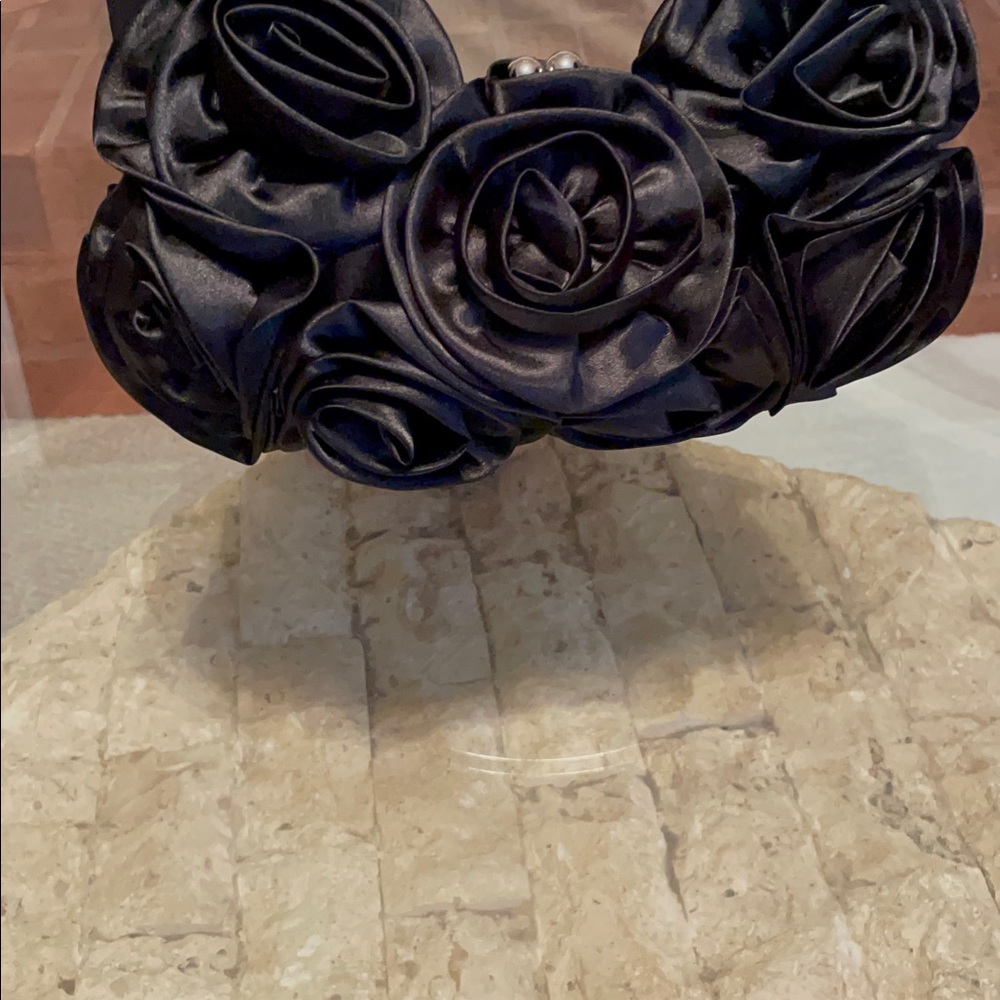 D’Margeaux flowered top gabled evening bag.